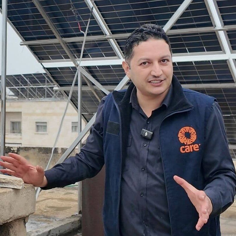 Kahalil steht vor einer Solaranlage Kahalil steht vor einer Solaranlage.