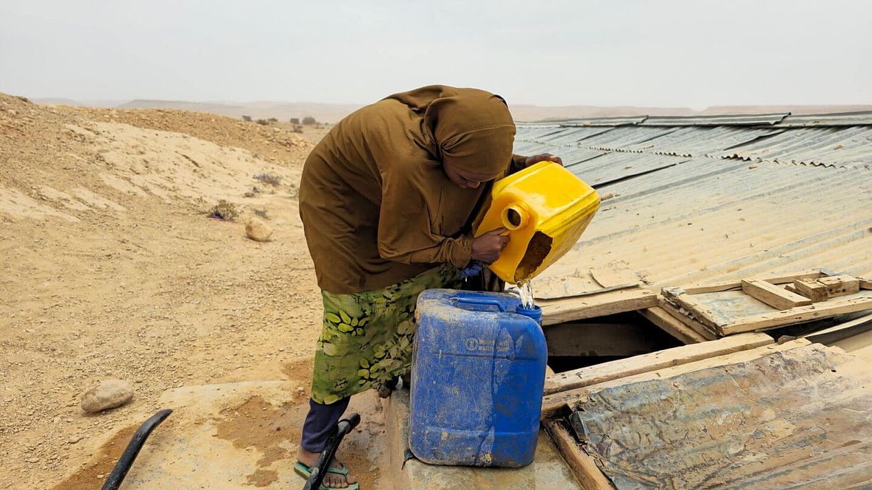 Sumaya befüllt Wasserkanister Sumaya füllt einen Wasserkanister auf.